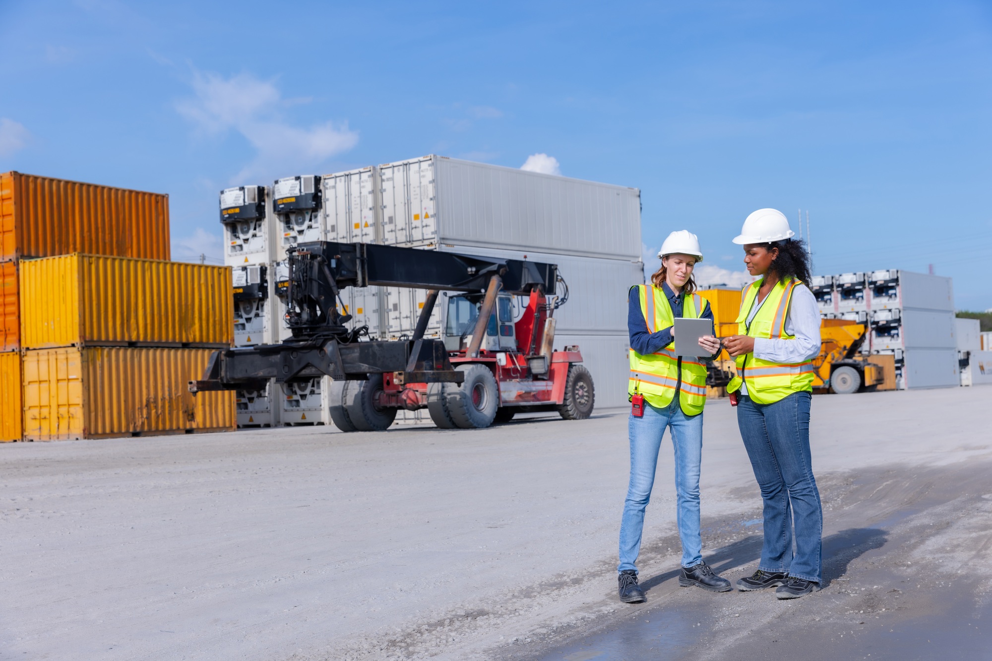 Female Workers Discussing Logistics at Container Yard