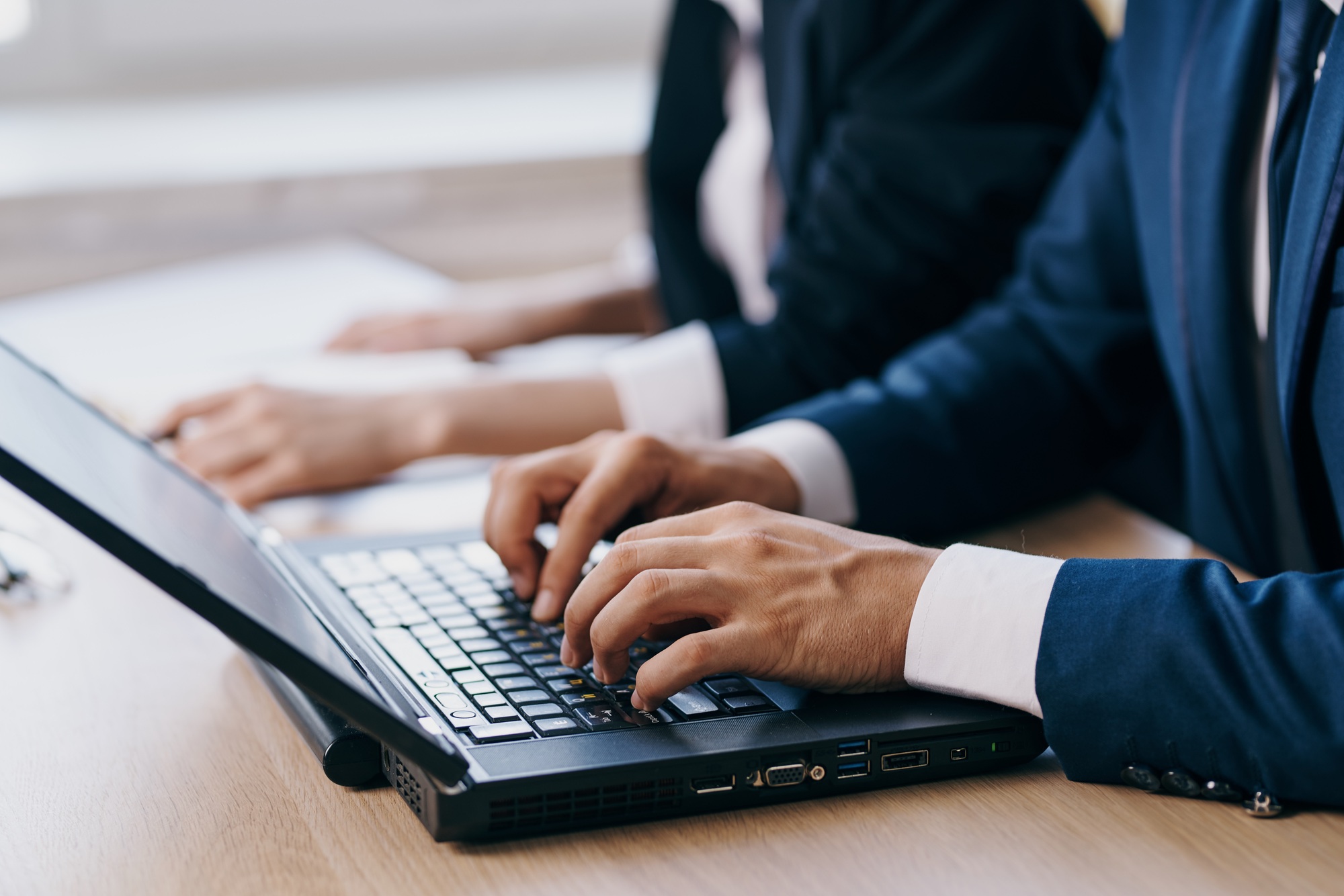 managers in the office in front of a laptop career network technologies