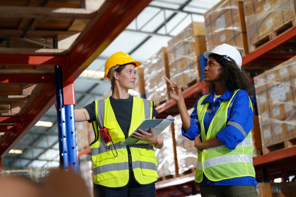 Young warehouse workers working together. Business distribution supply and logistic shipment.