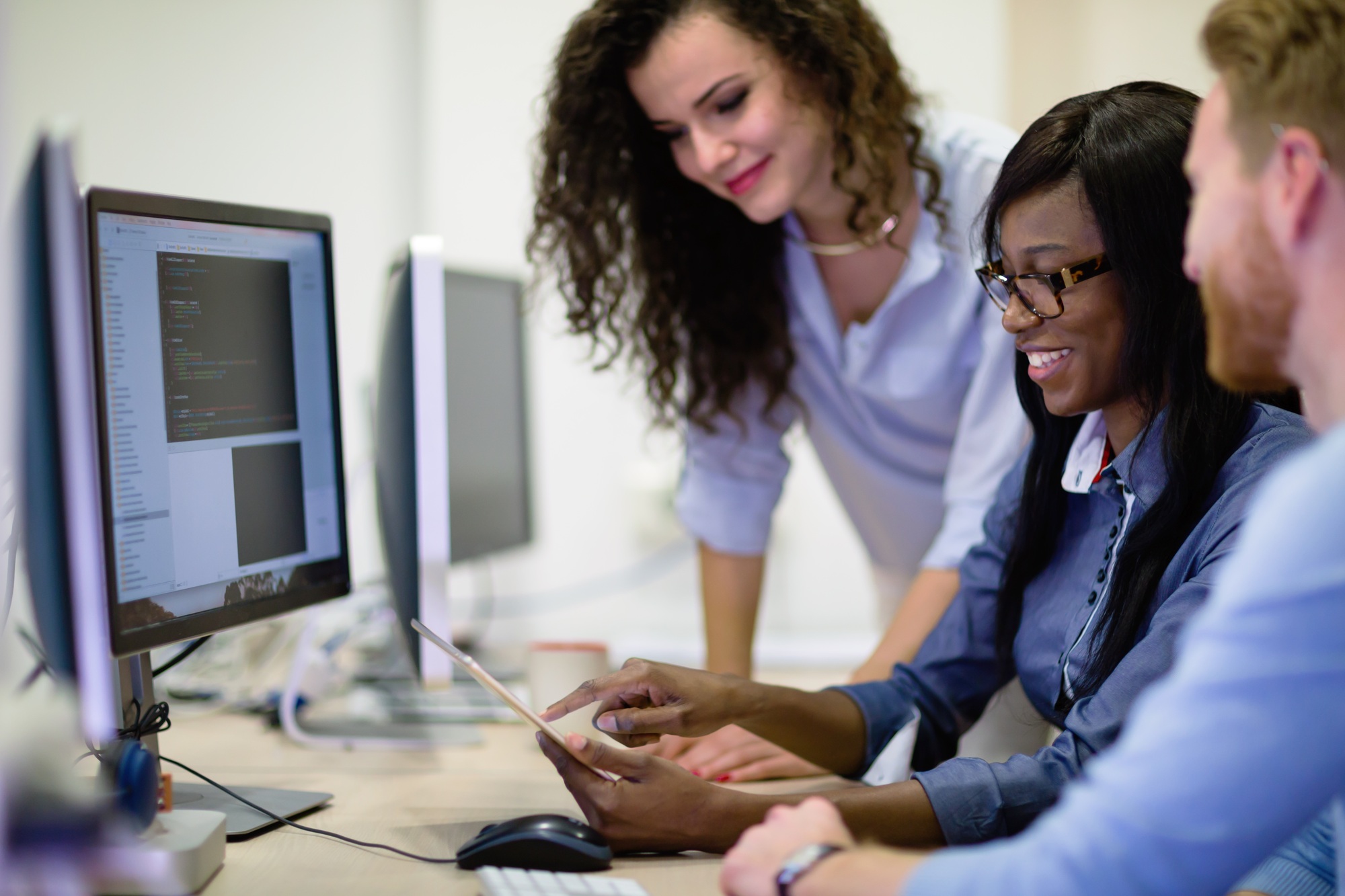 Programmers cooperating at information technology company
